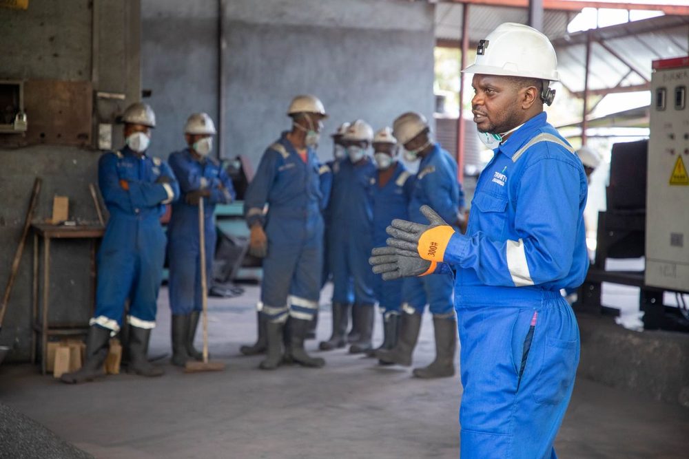 Workplace safety training session with hard-hat-wearing staff.
